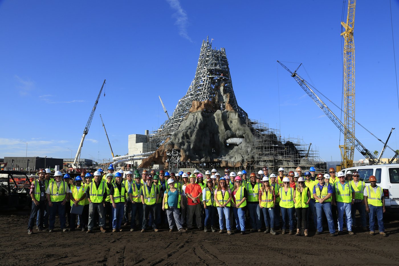 Volcano Bay — construction team in front of volcano structure